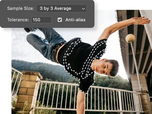 Sample Size, Tolerance, and Anti-alias settings superimposed on a photo of a person doing acrobatics. The person's pant leg has been selected using the Magic Wand tool.