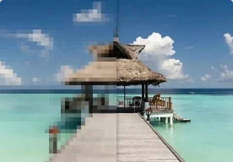 A photo of a tropical beach. Half the photo is pixelated.