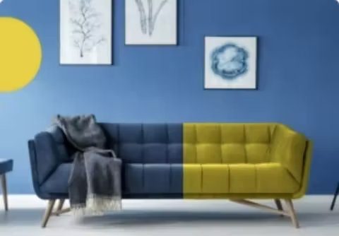 An image of a couch in a living room. Half the couch is blue and the other half is yellow.
