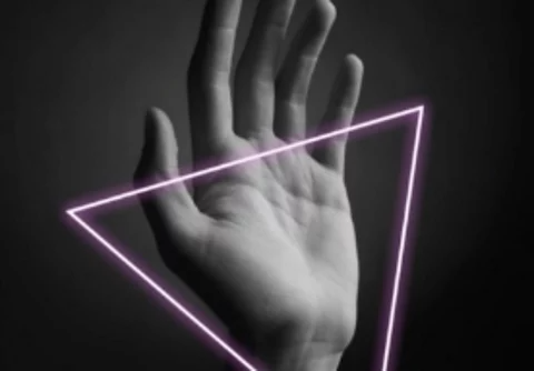 An image of a person's hand with a neon pink triangle.