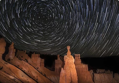 A time-lapse image of a starry night sky.