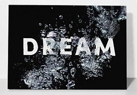 A photo of air bubbles in water on a black background is enhanced with the text dream