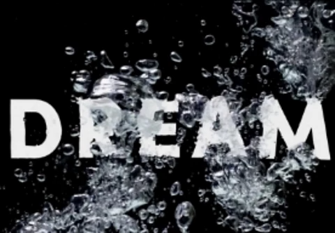 An image showing the word "DREAM" floating in water.