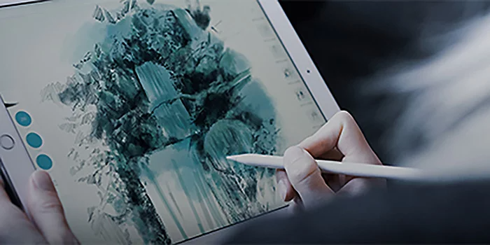 A person using a digital pencil to sketch a blue waterfall landscape on a tablet