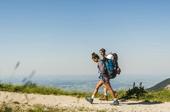 Photo, using the rule of thirds, of a man and woman hiking on a path