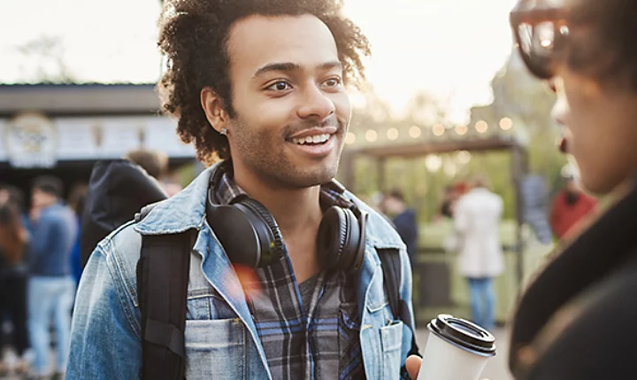 A candid portrait photo of a person standing outside.