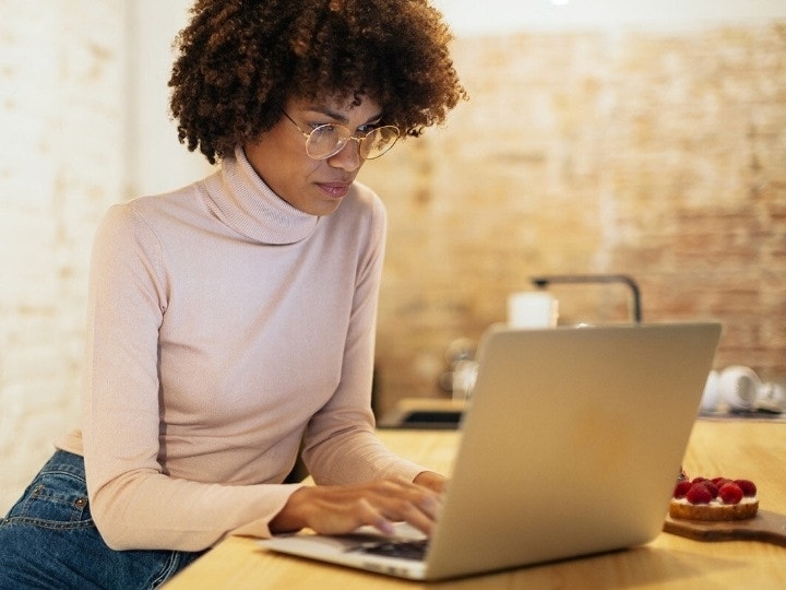 A person working on their digital document contingency plan in their kitchen