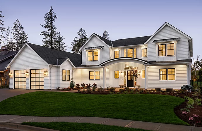 Photo of a house taken at nighttime with all the lights on giving it a glow