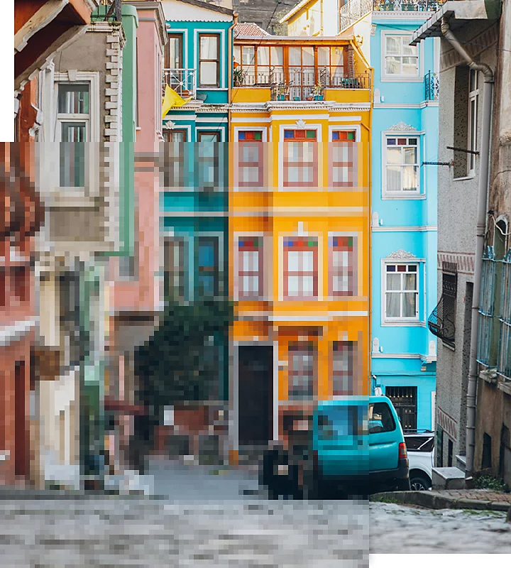 A picture of buildings along a street that is half pixelated and half in focus