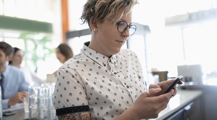 A business owner checking their phone in their establishment