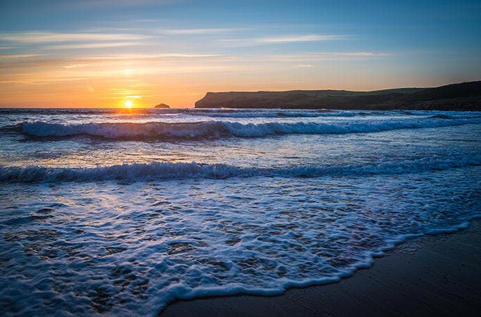 Fast shutter settings used to capture a precise image of ocean waves in the sunset