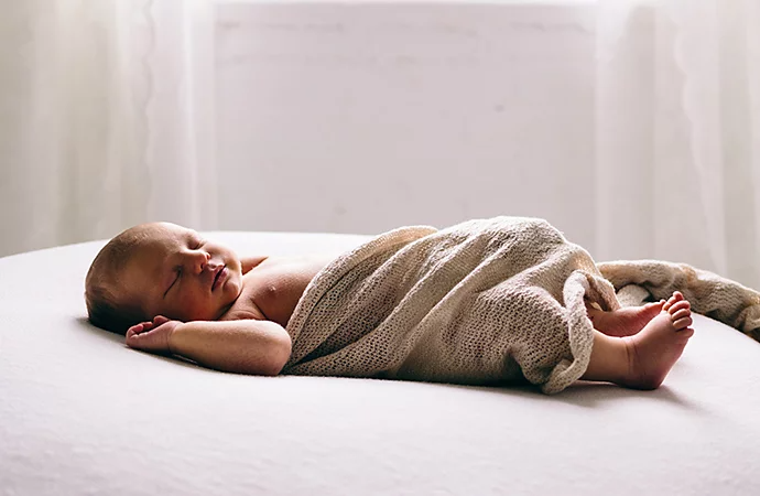 A newborn baby swaddled in cloth