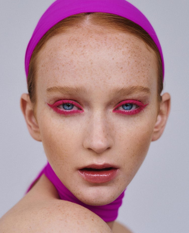 Close up of women with pink makeup and hair accessories.