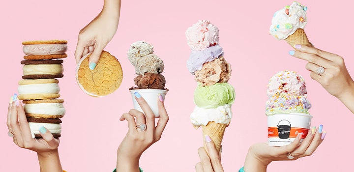 Hands holding different ice cream treats.