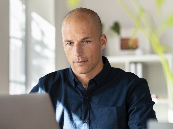 A person working on redacting a PDF on their computer