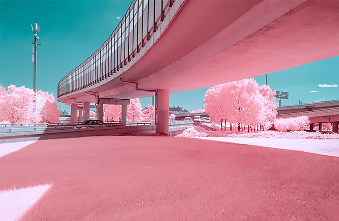 Infrared photo capturing a cityscape in front of a waterfront park