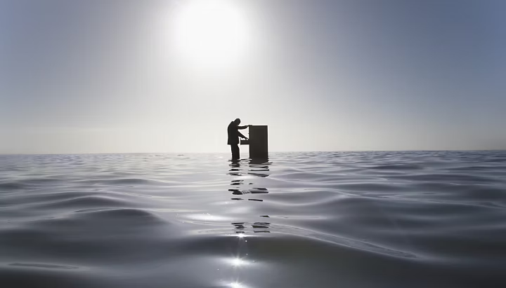 Someone opening a filing cabinet as they float above a body of water