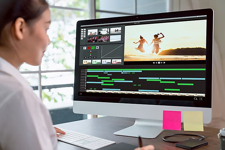 an image of a person editing photos at their computer