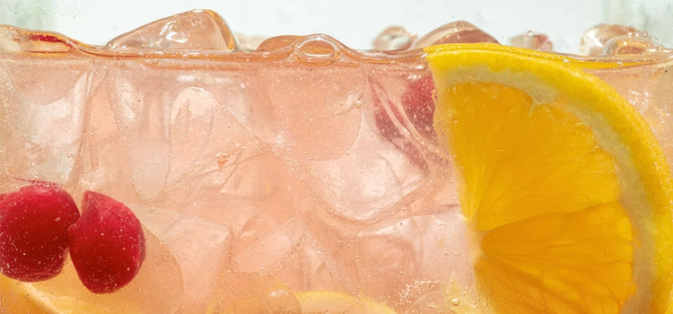 close-up-of-lemon-slices-and-cherry-in-lemonade-and-ice-cubes-background-texture-of-cooling-sweet-summer-s-drink-with-macro-bubbles-on-the-glass-wall-fizzing-or-floating-up-to-top-of-surfac