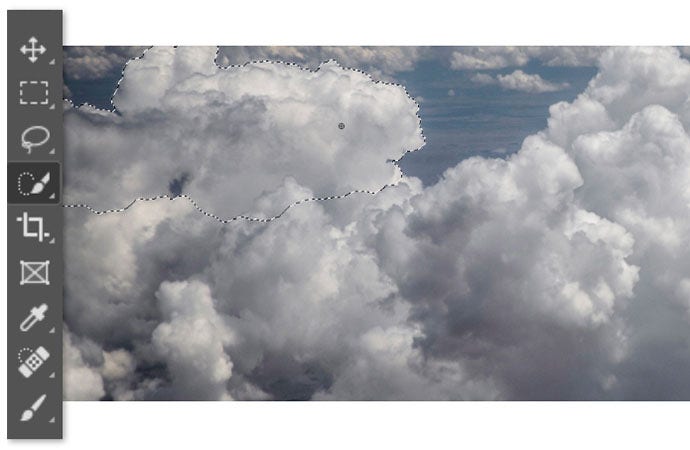 Adobe Photoshop tool interface next to image of clouds