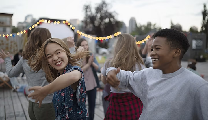 A-roll of two people dancing outside at a party