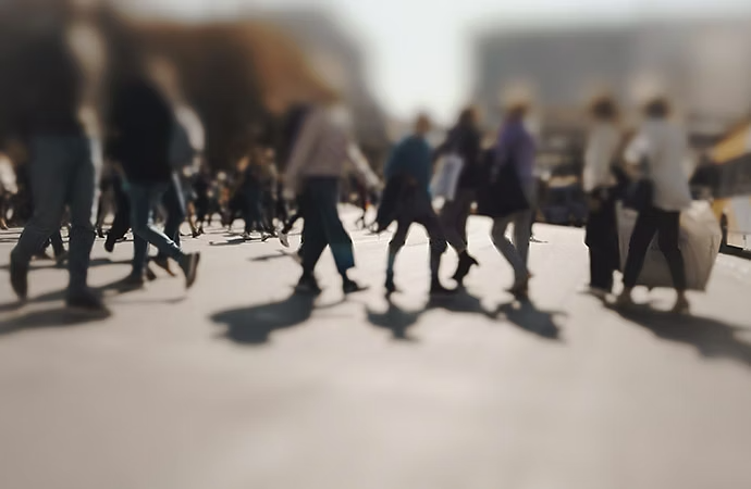 A blurry photo of people walking in a city.