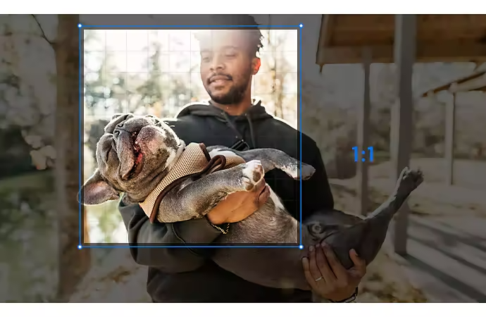 A photo of a person holding a dog being cropped to a 1:1 aspect ratio