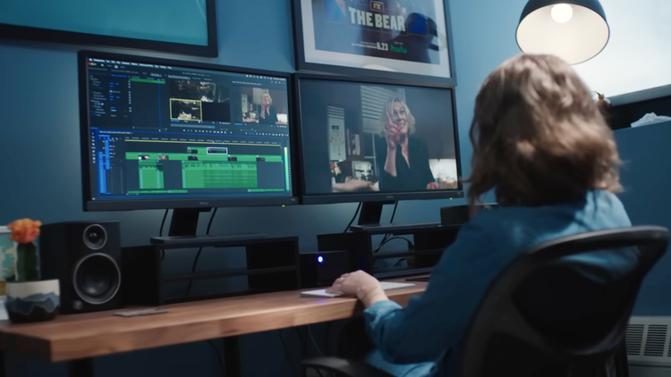 photo of a woman editing movie on her two computers