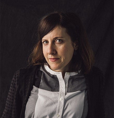 Headshot picture of a woman looking semi-seriously at the camera