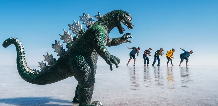 Toy dinosaur appears larger than people using forced perspective