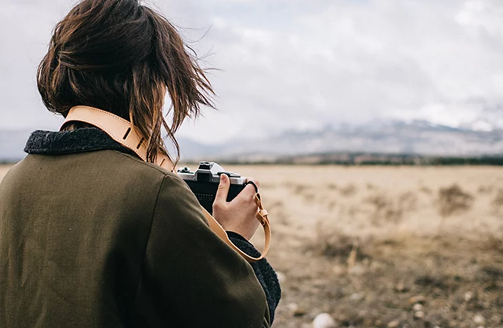 A person taking a photo with a film camera