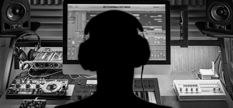 Music producer using a graphic equaliser on their digital audio workstation.