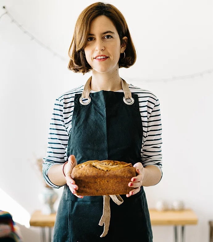 A person holding a loaf of banana bread